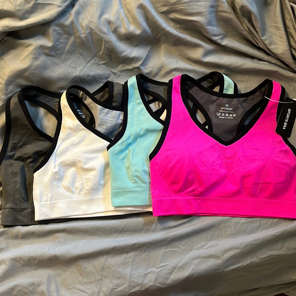 4 sports bras. 1 NWT and has cup pads. 3 washed but not worn no cup pads
